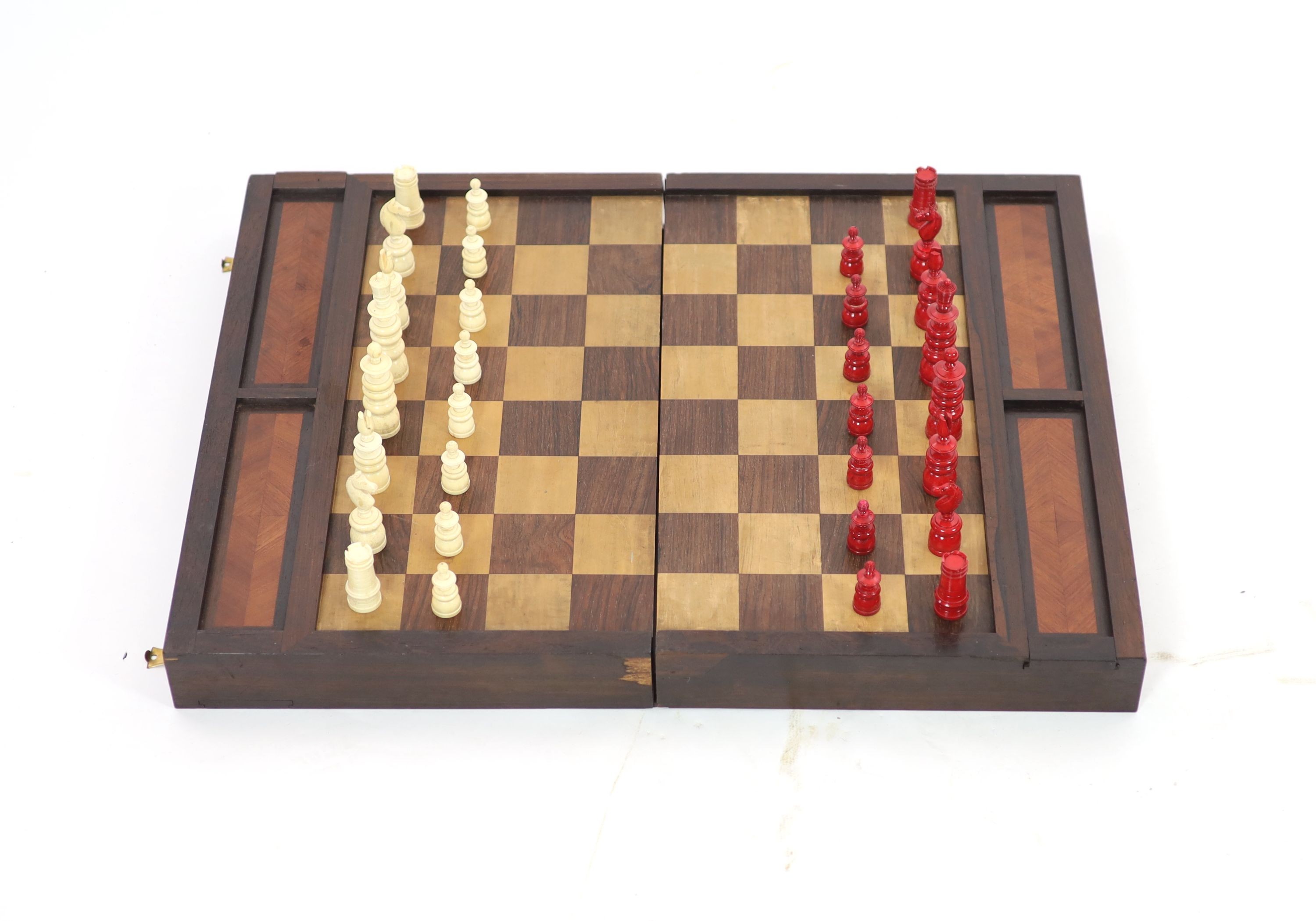 An early 20th century rosewood folding games board, external chess and internal backgammon, W 75cm D 56cm when open, W 75cm D 37cm when closed